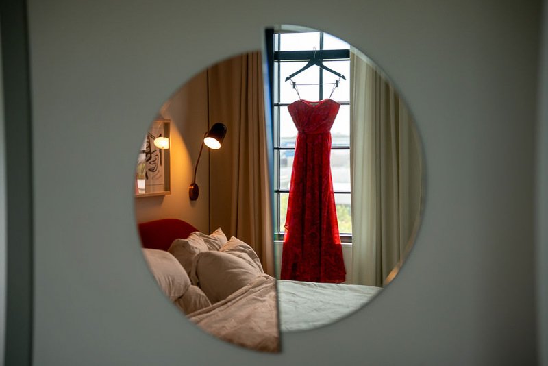 0004_Reflection of a red dress hanging by a bedroom window.jpg