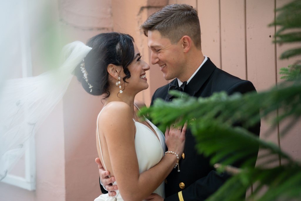 A bride and groom smiling and looking into each other s eyes on their wedding day.jpg