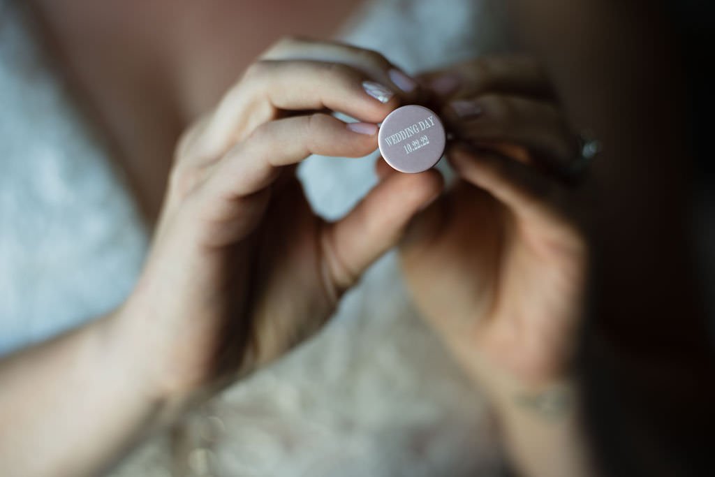 A bride holds a special keepsake for her wedding day.jpg