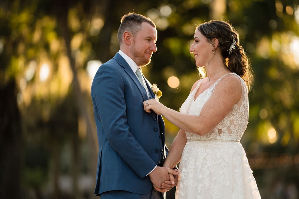 A bride lovingly adjusts her groom s boutonniere before their wedding ceremony.jpg