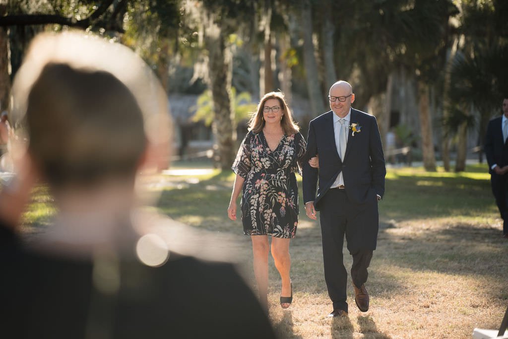 A bride s parents walk down the aisle ready to see their daughter get married.jpg