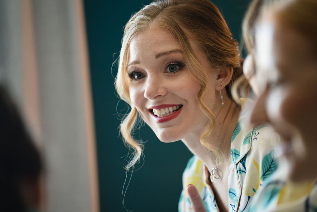 A bride to be smiles as she shares a laugh with her bridesmaids bridetobe gettingready weddingday.jpg