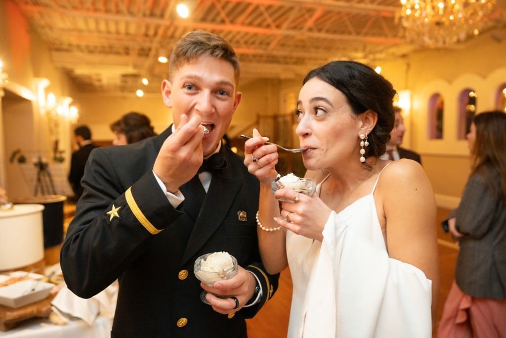 A happy couple enjoys ice cream together at an elegant event.jpg