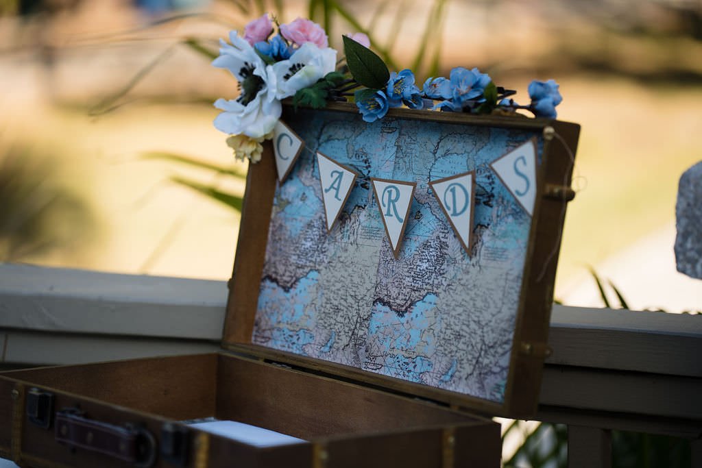 A vintage suitcase adorned with flowers ready to collect wedding well wishes.jpg