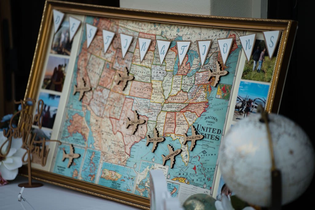 A vintage travel themed wedding sign with photos and a map of the US.jpg
