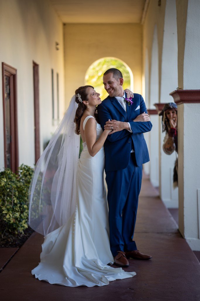 Bride and groom share a loving glance on their wedding day framed by a beautiful courtyard.jpg