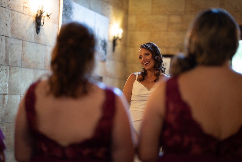 Bride smiling with bridesmaids nearby.jpg