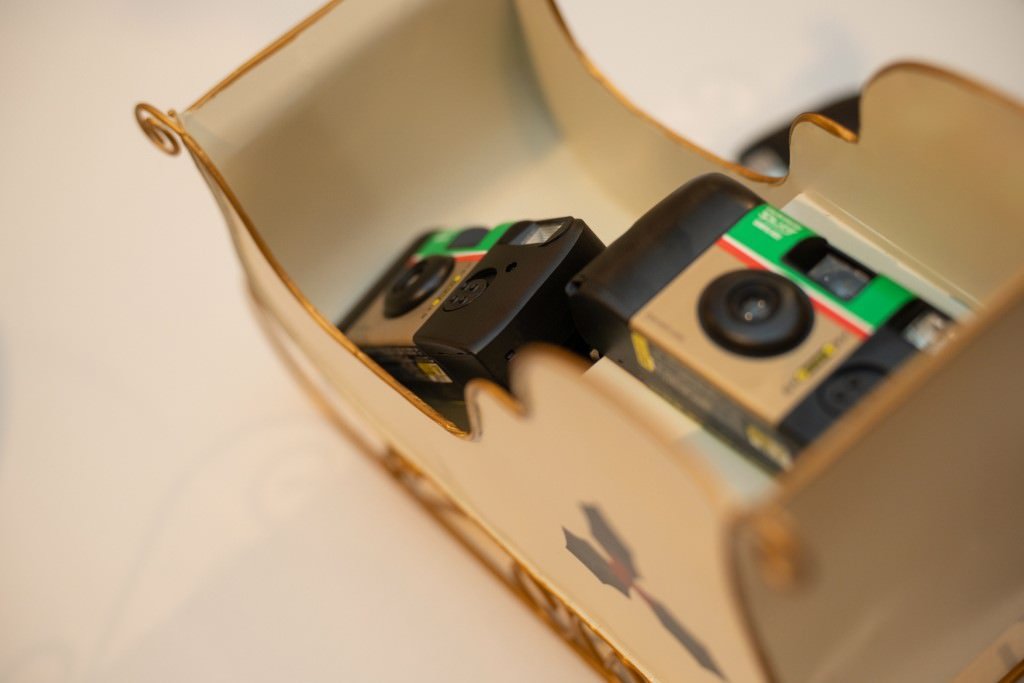 Disposable cameras in a decorative holder ready for use.jpg