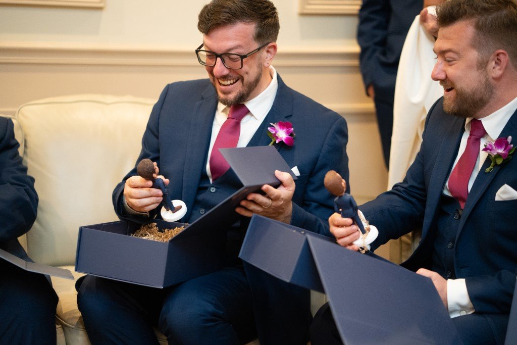 Groomsmen with custom bobbleheads laughing.jpg