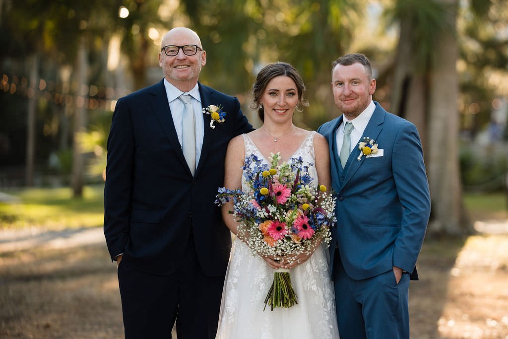 Happy couple with the father of the bride on their wedding day.jpg