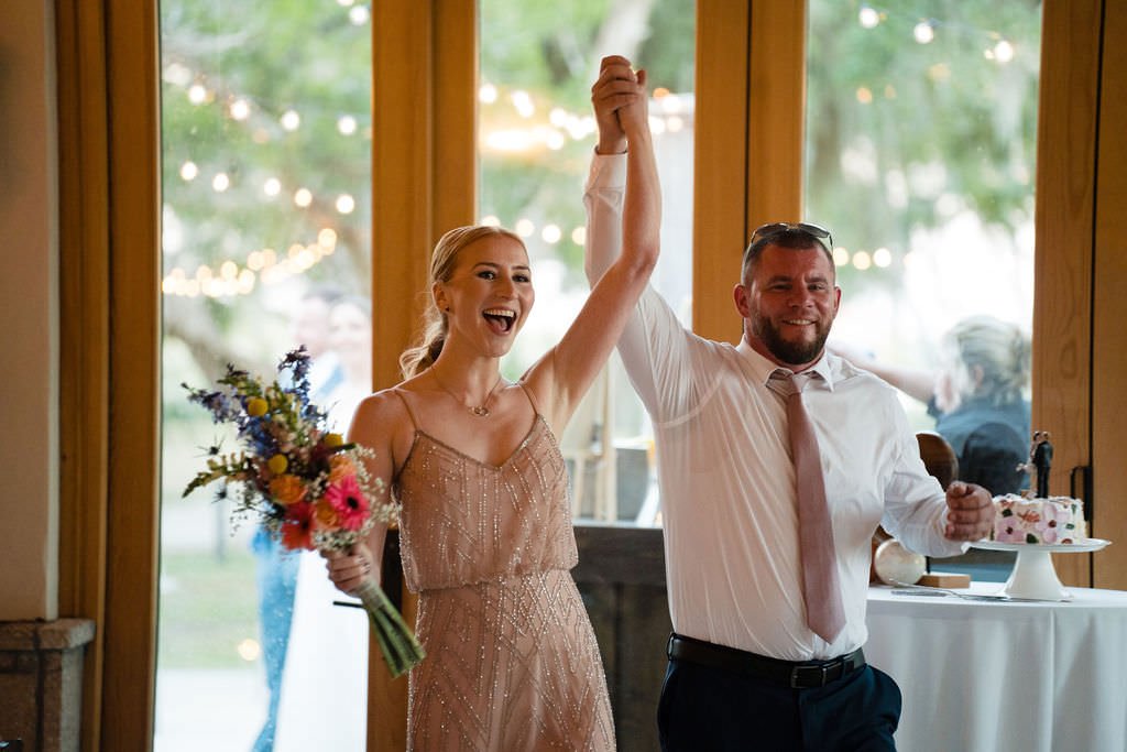 Newlyweds celebrate their love with a joyous entrance at their wedding reception.jpg