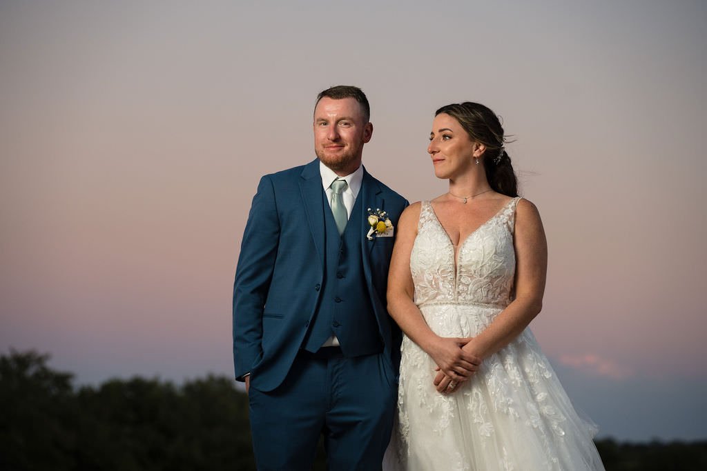 Newlyweds gazing into the sunset on their wedding day.jpg