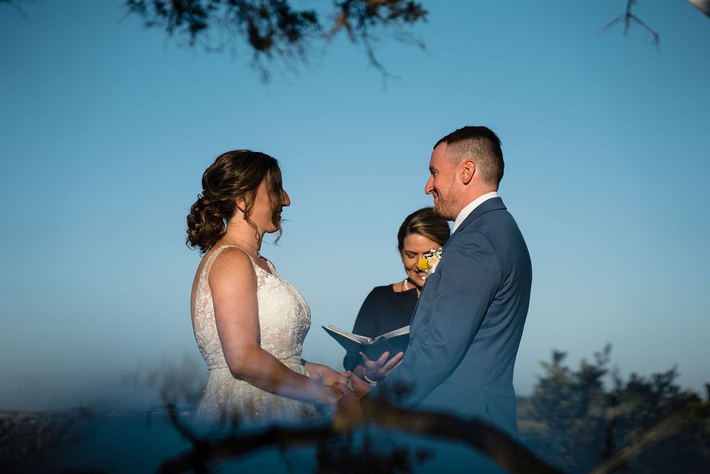 The bride and groom exchange vows under a clear blue sky weddingday happilyeverafter lovewins.jpg