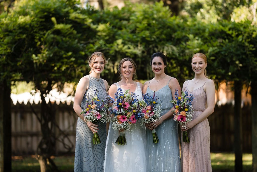 The bride and her bridesmaids pose with matching bouquets They look beautiful and ready to celebrate.jpg