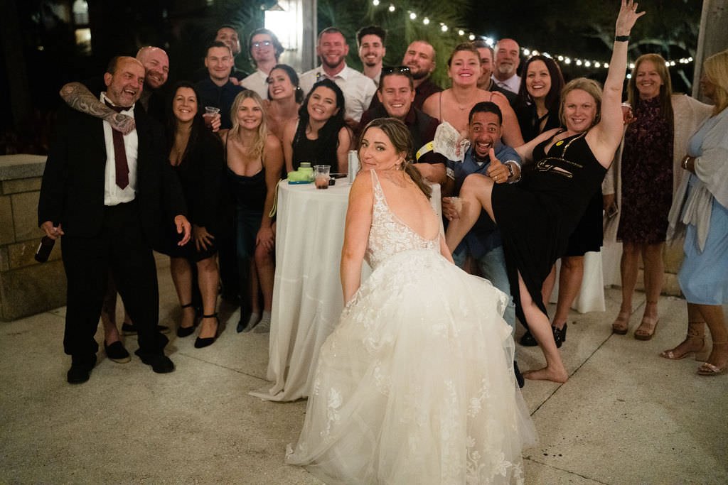 The bride is surrounded by loved ones at her wedding reception ready to celebrate the night away.jpg