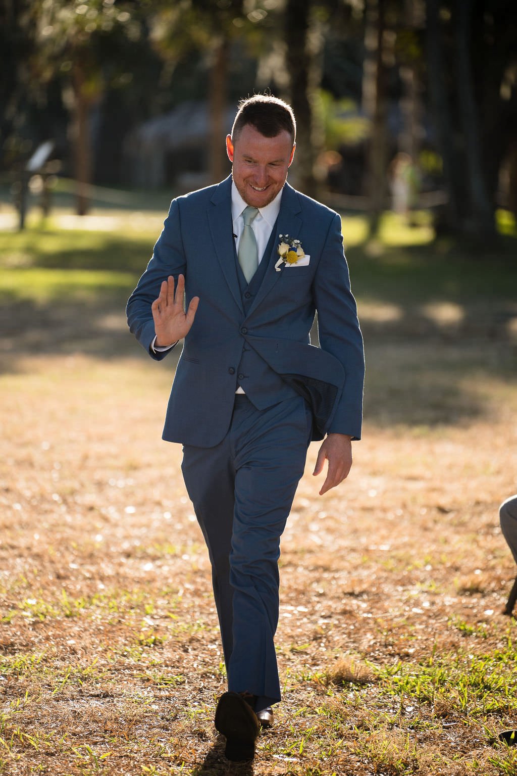 The groom walks down the aisle beaming with joy ready to say I do.jpg