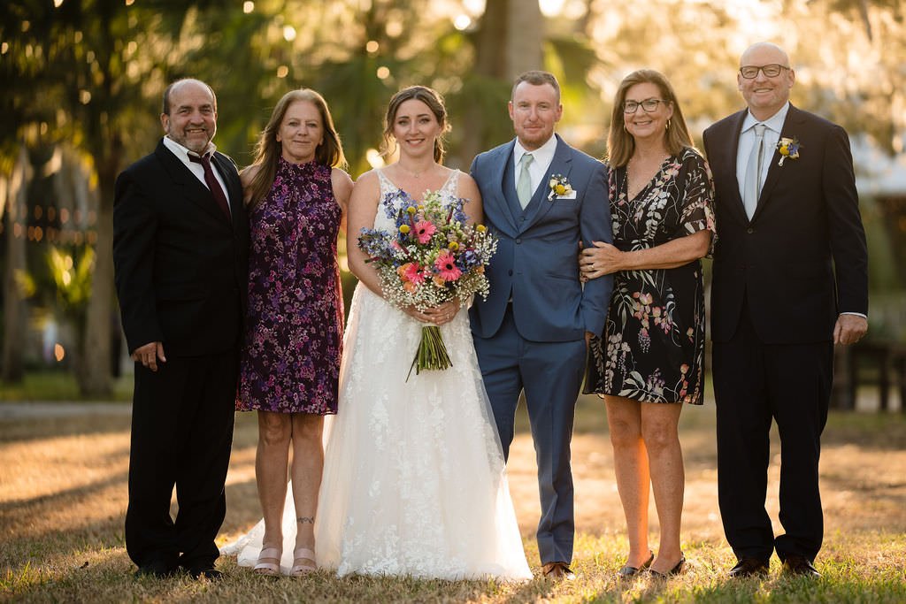 The happy couple surrounded by their loving family radiating joy and warmth on their special day.jpg