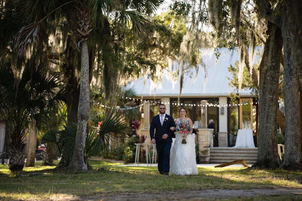 The happy couple walks down the aisle surrounded by lush greenery and the warm glow of the afternoon sun justmarried weddingday happilyeverafter.jpg