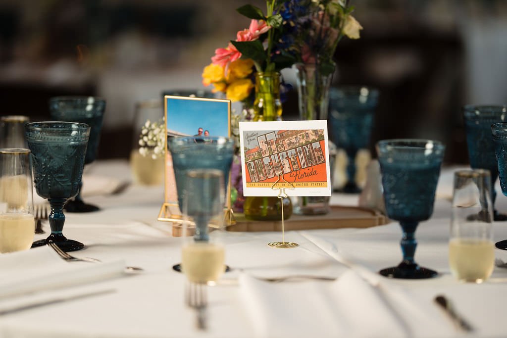 Vintage postcard table setting adds a touch of nostalgia to this elegant wedding reception.jpg