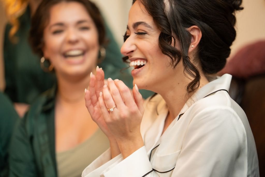 Woman laughing and clapping with friends.jpg
