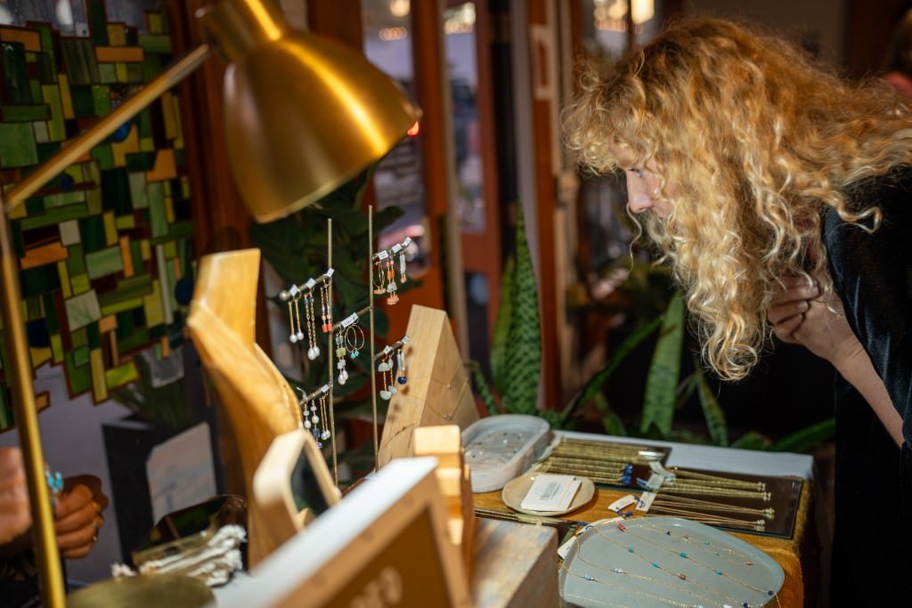 Admiring handcrafted jewelry display.jpg