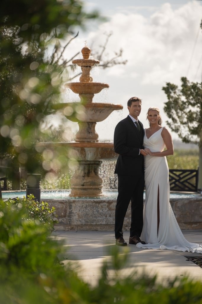 Newlyweds posing by fountain.jpg