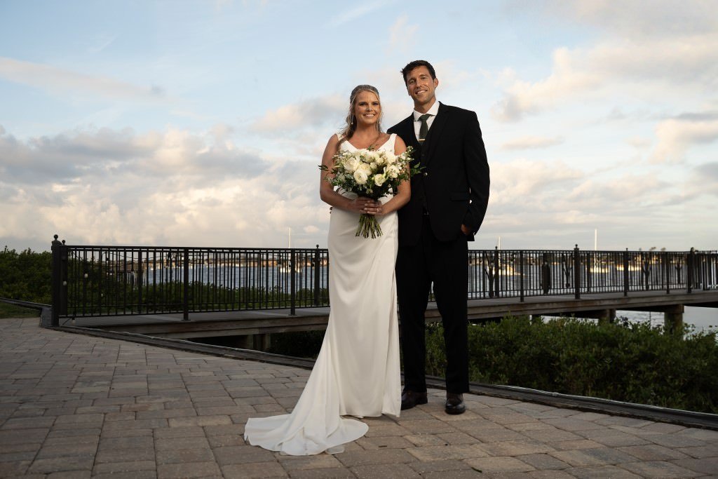 Newlyweds posing by waterfront.jpg