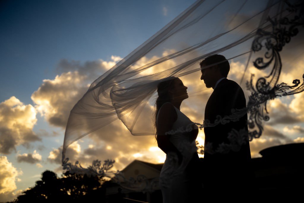 Newlyweds silhouetted against sunset.jpg