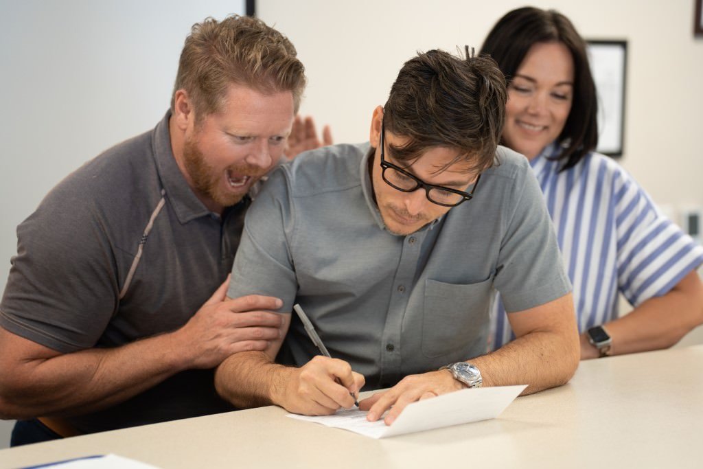 Signing papers with enthusiastic support.jpg