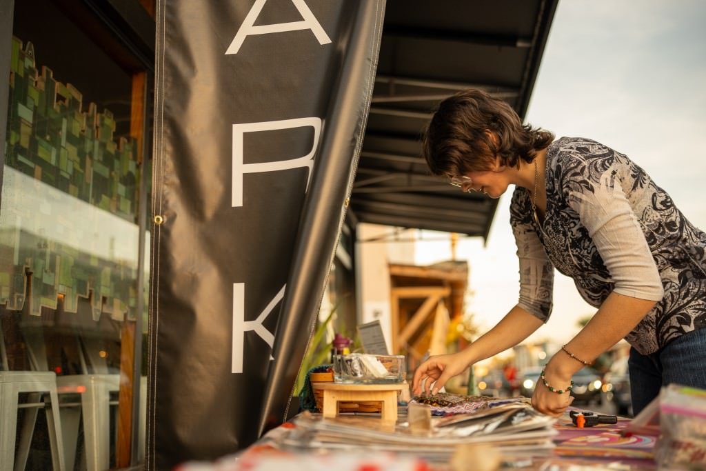 Street artist arranging art display.jpg