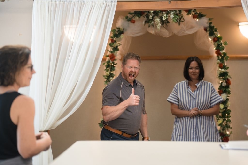 groom gives thumbs up at wedding venue.jpg