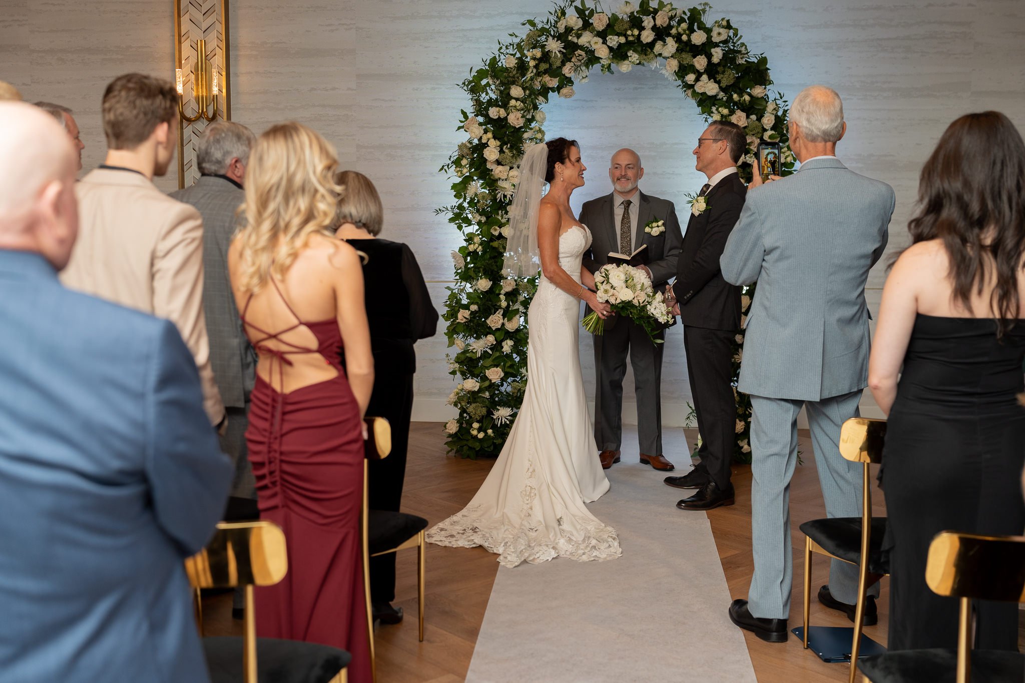 Wedding ceremony under floral arch.jpg