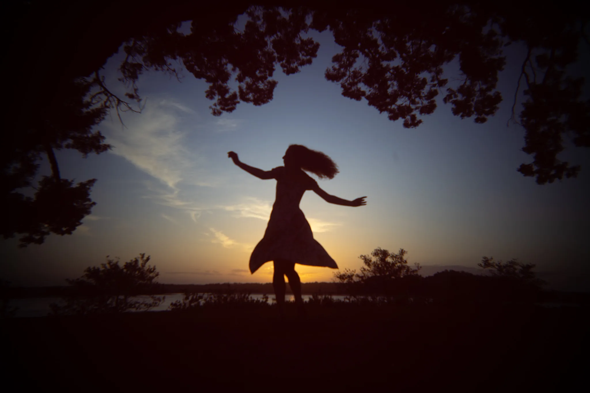 girl twirling at sunset
