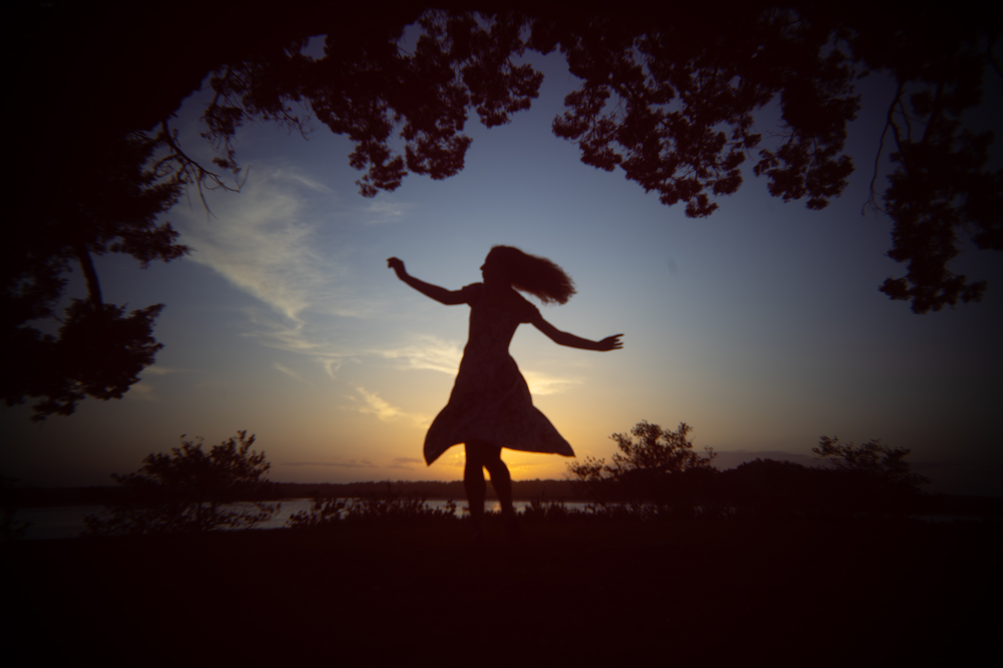 girl twirling at sunset